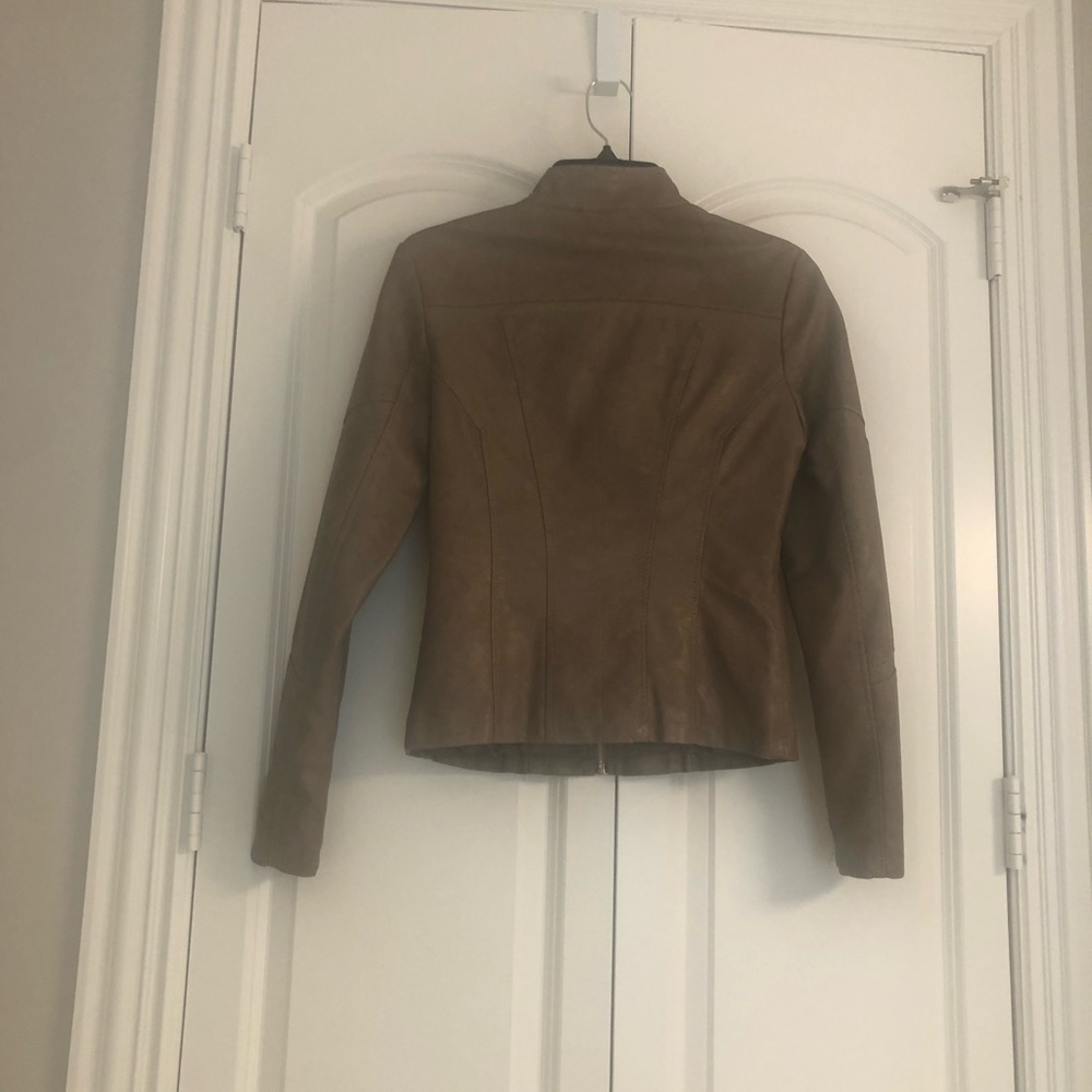 Fitting jacket with pockets. Dark camel color Faux leather look -soft texture